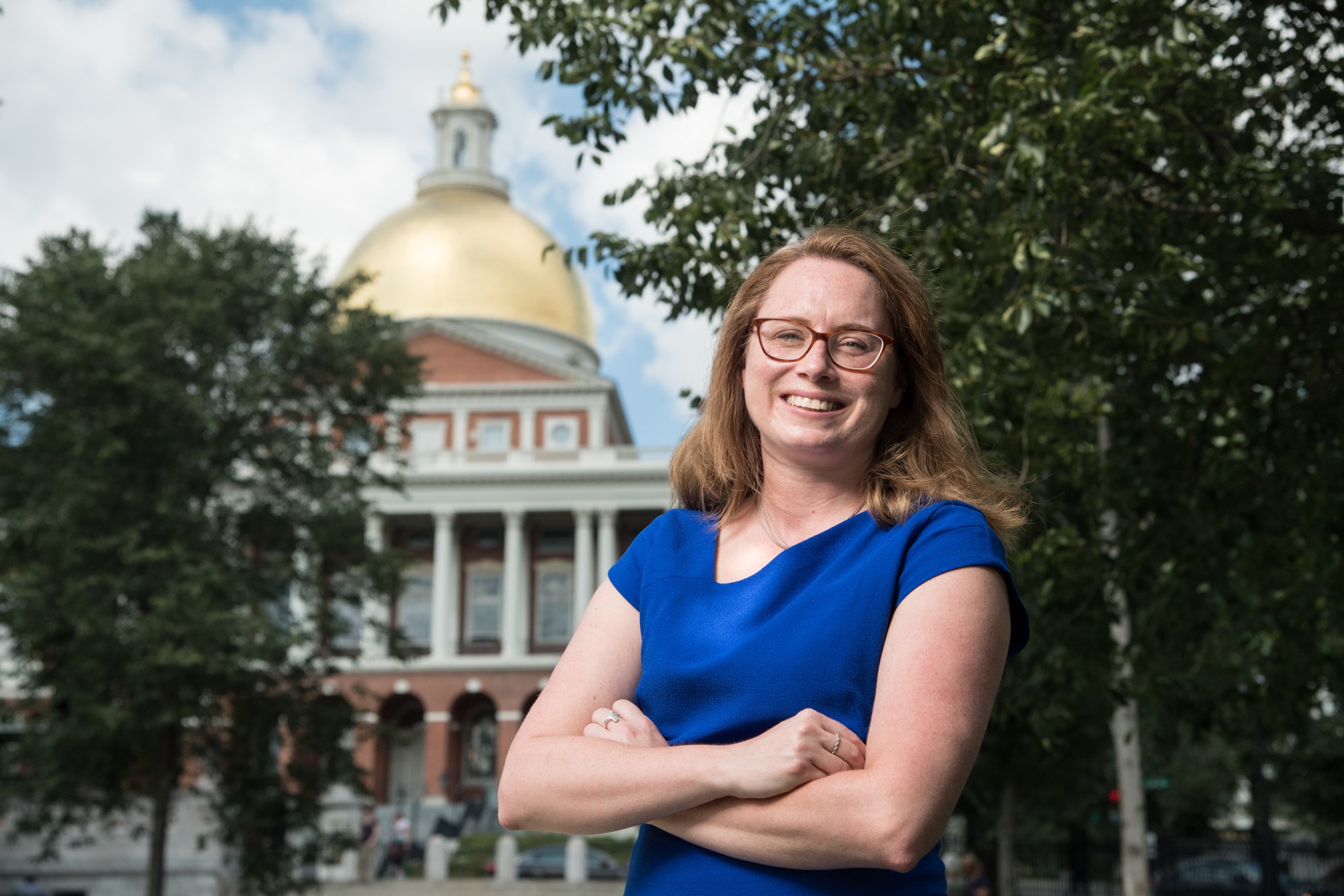 Christine Barber standing in front of the Massachusetts State House dome