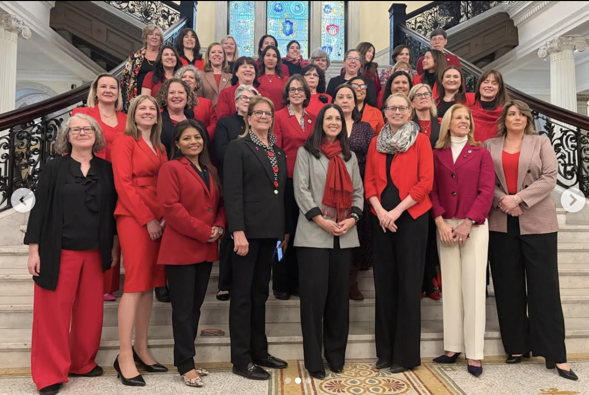 Christine Barber with women legislators on the State House stairs